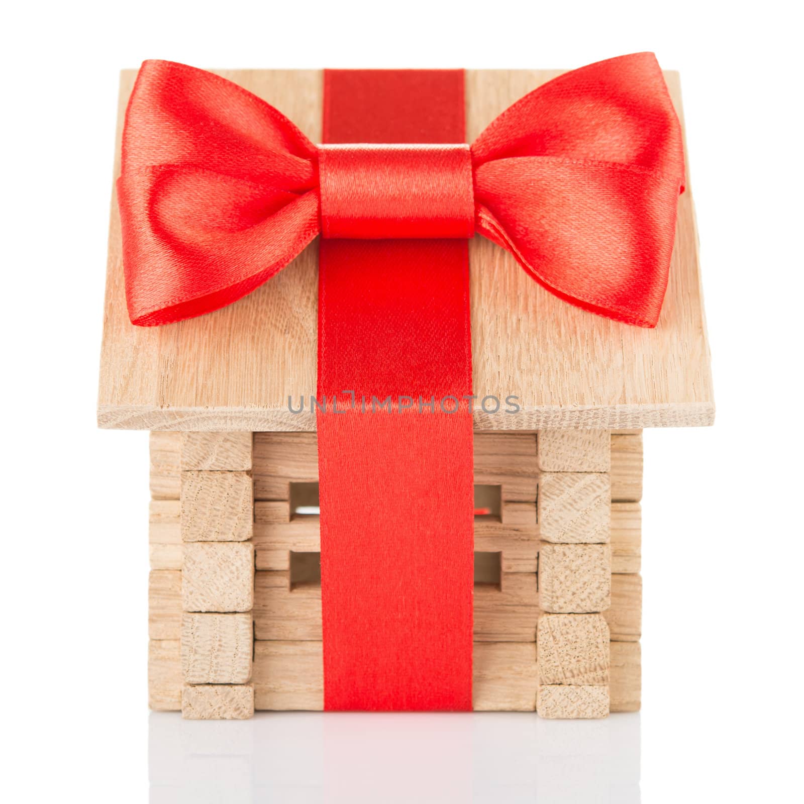 Small wooden house with red bow and ribbon