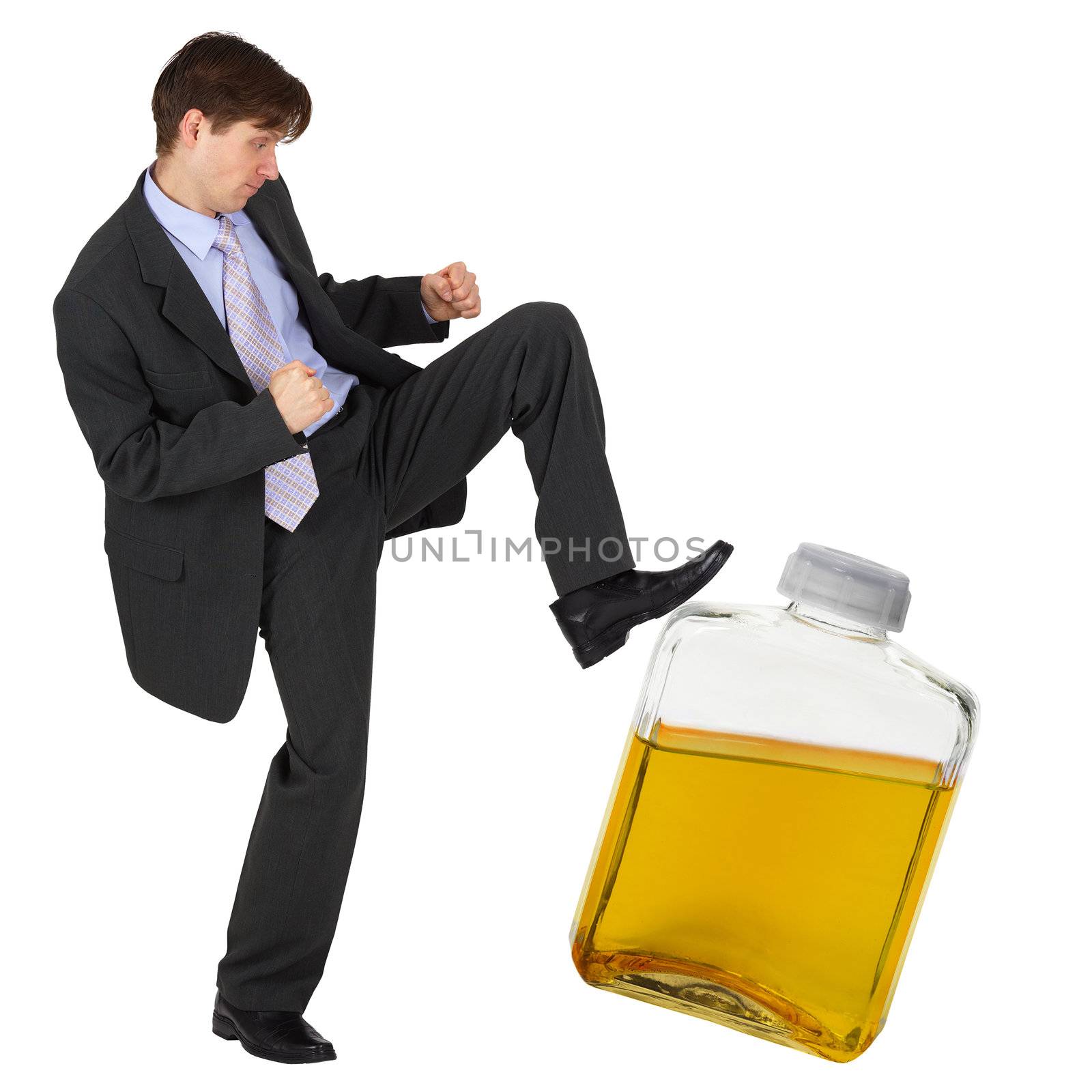 A man kicks a bottle of yellow liquid