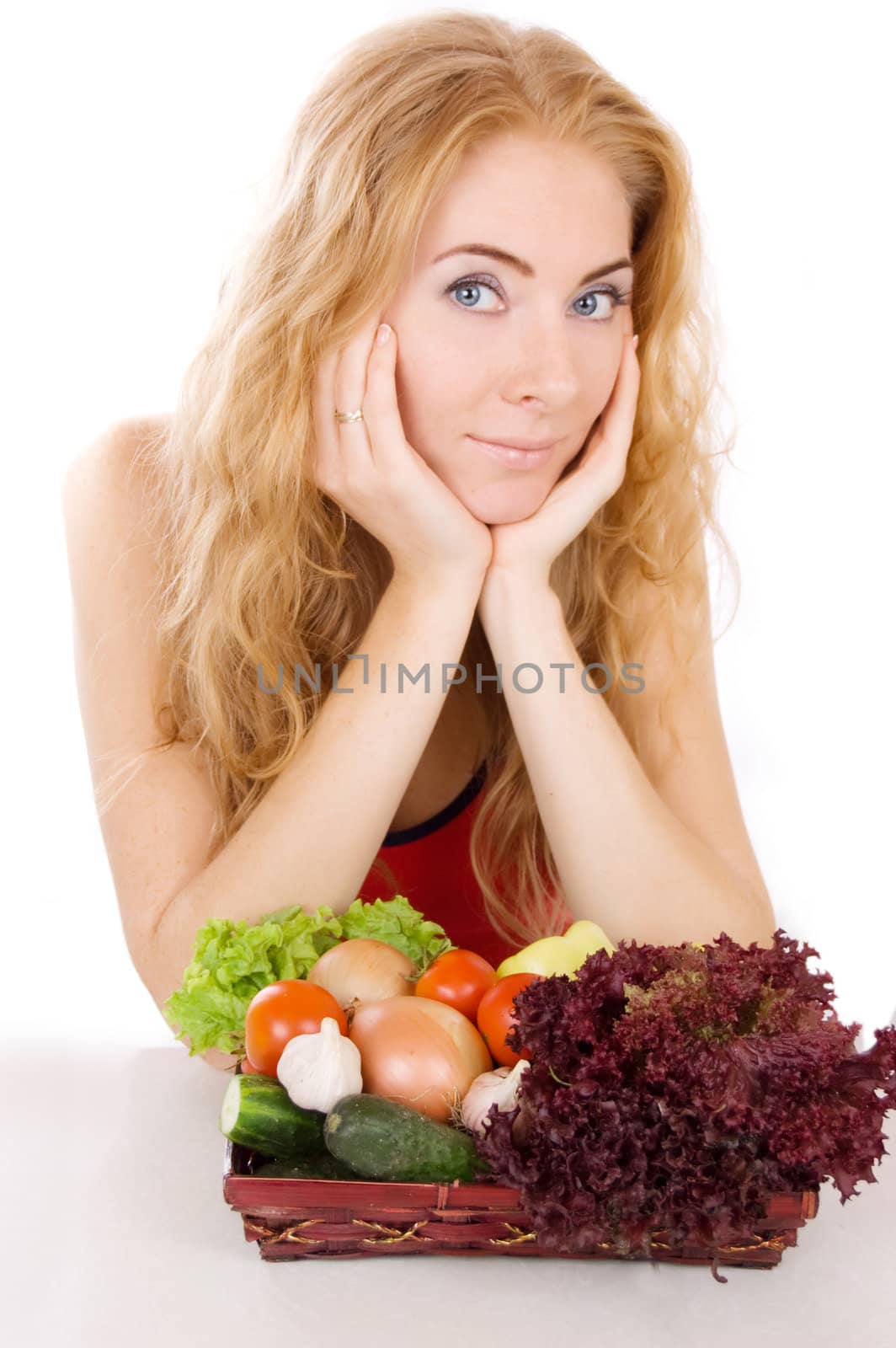 Red-headed woman with vegetables over white background