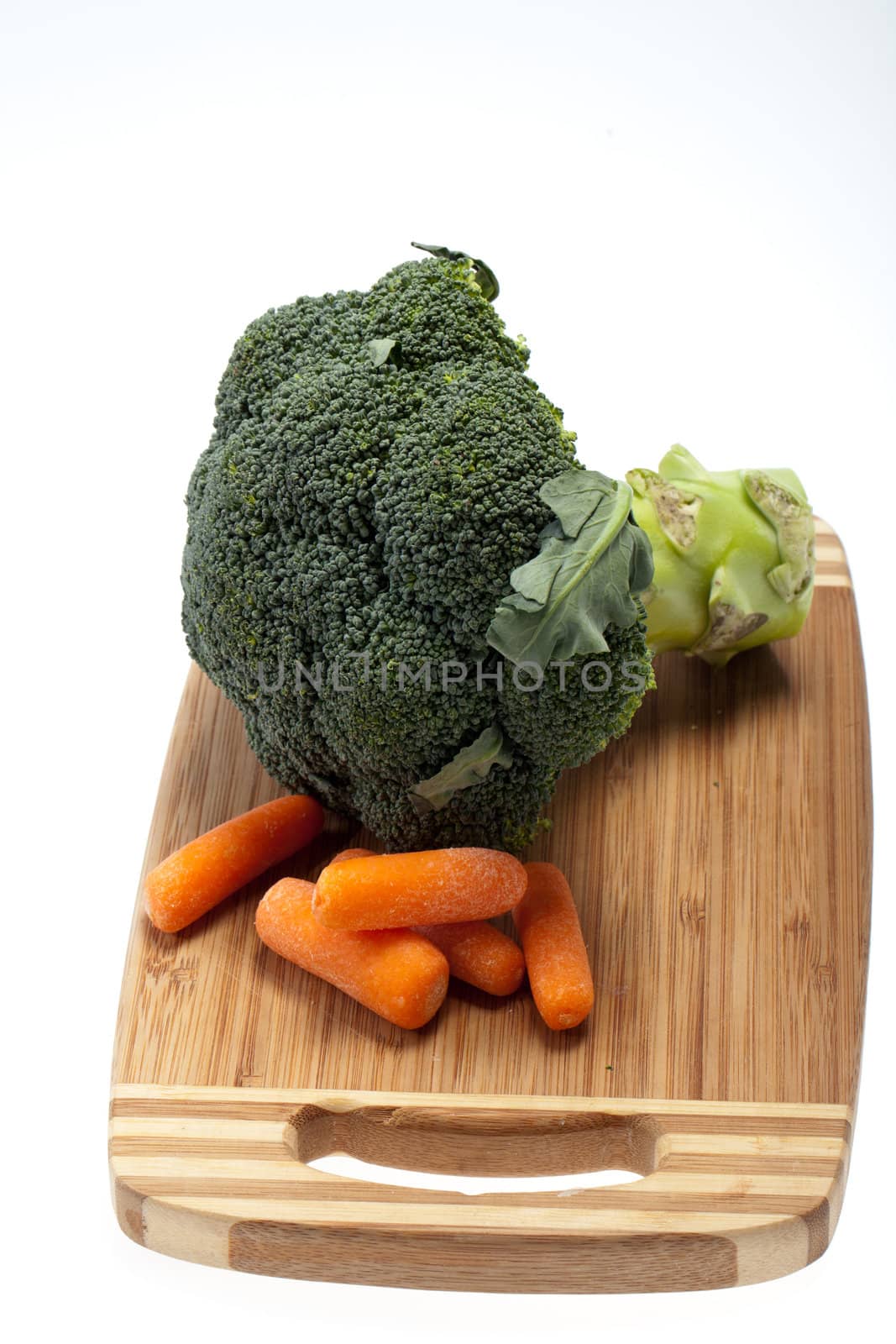 brocolli and carrots on the cutting board on the white background 