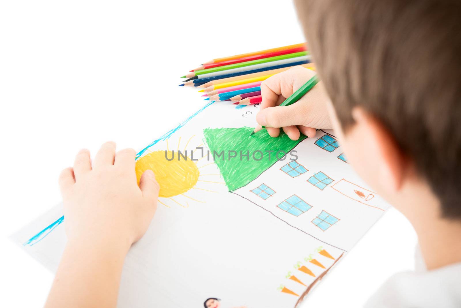 Child drawing a home with pencil