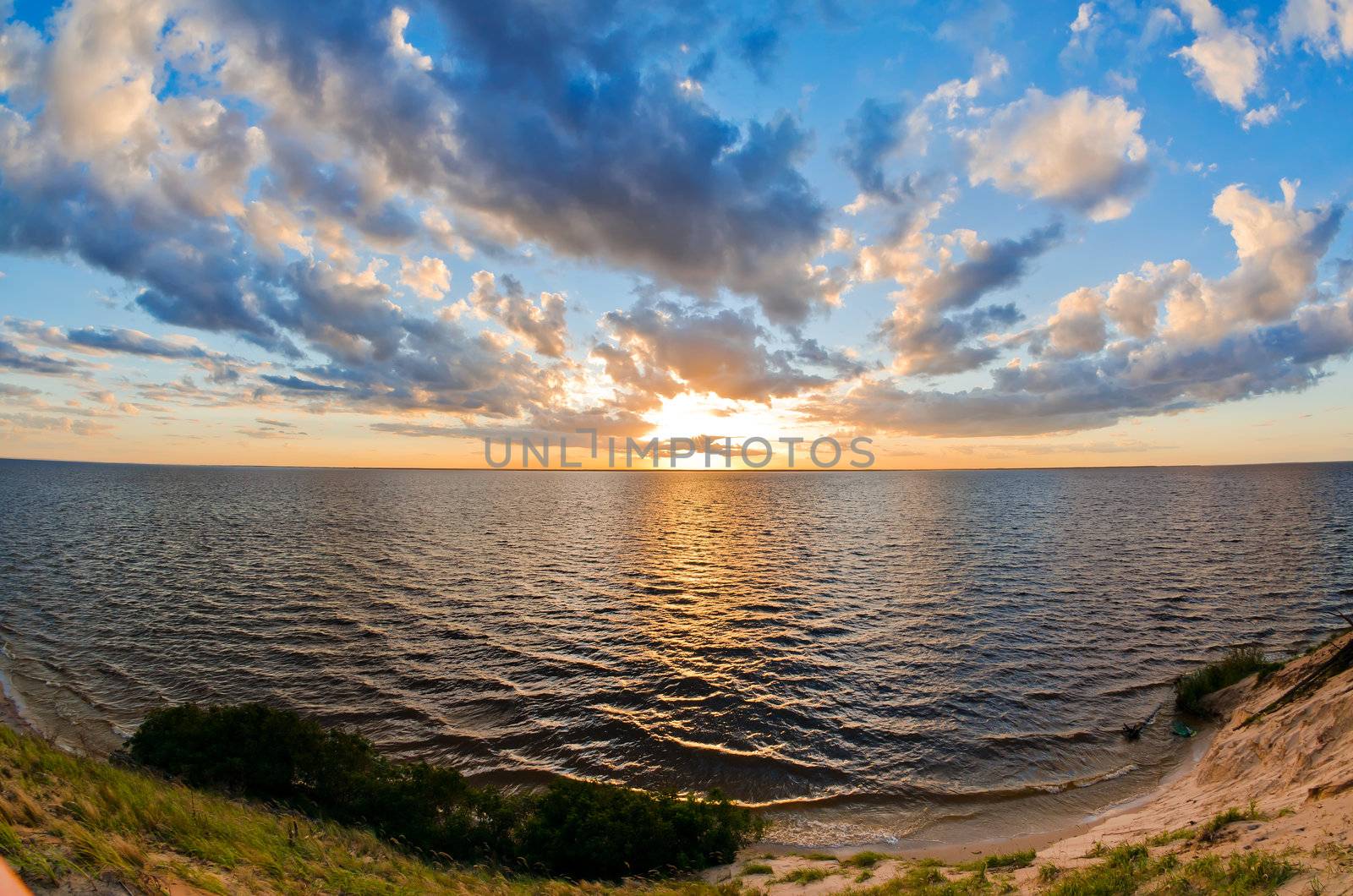 beautiful sunset over the smooth surface of a mountain lake