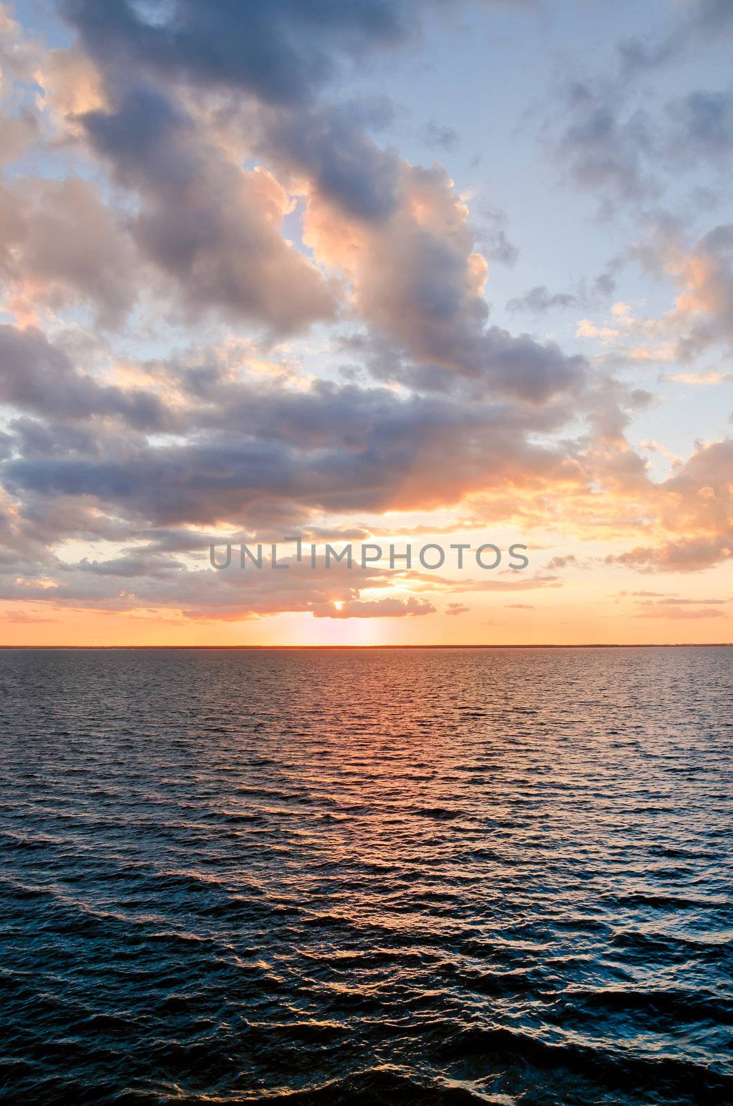 beautiful sunset over the smooth surface of a mountain lake