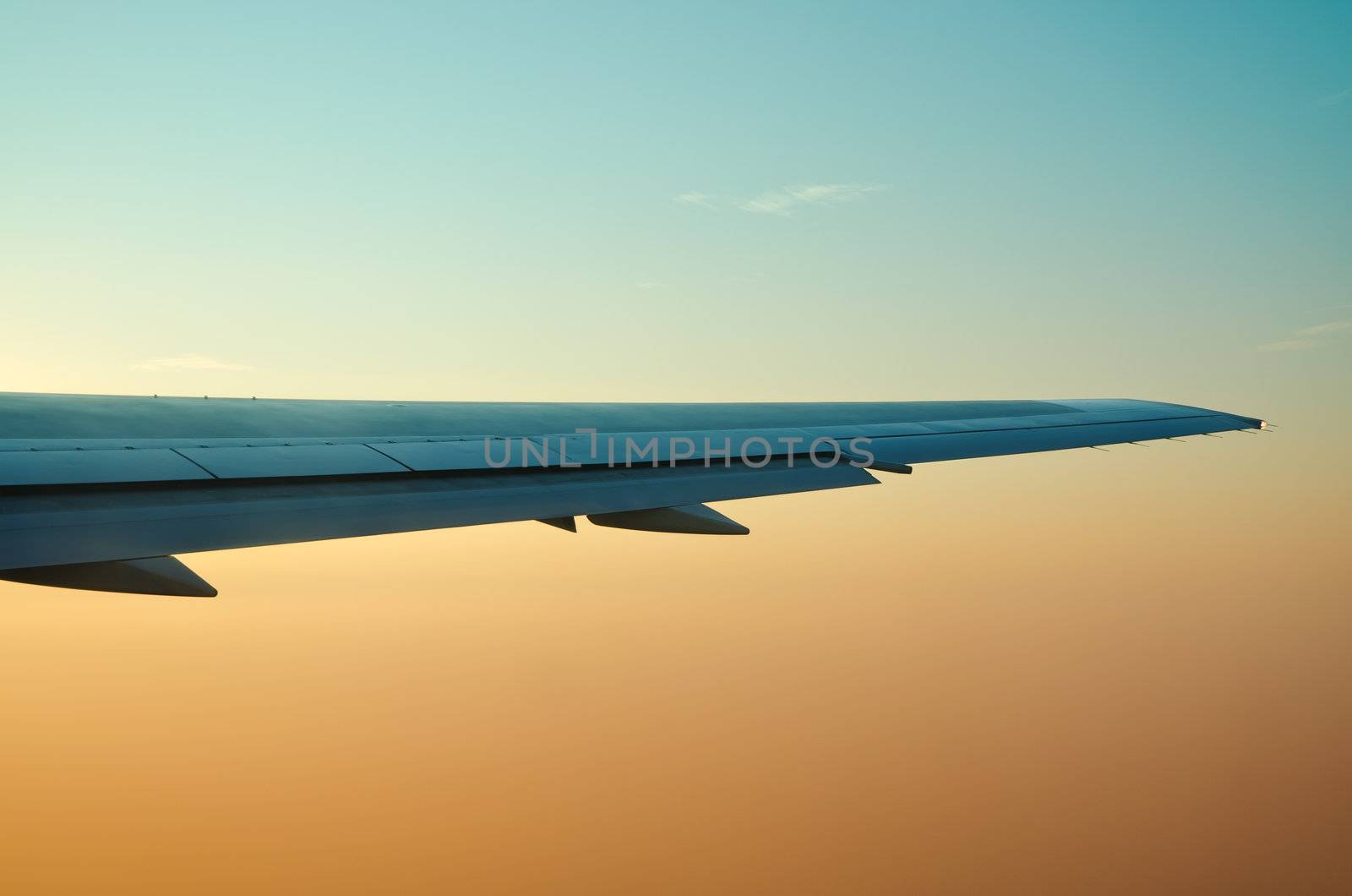 wing of an airplane and low clouds