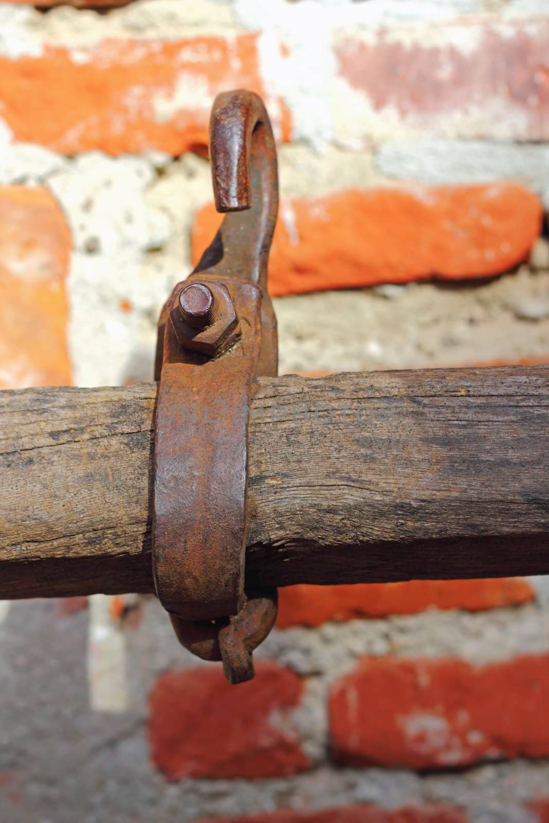 detail of axle with rusty metal hook from a very old traditional cart