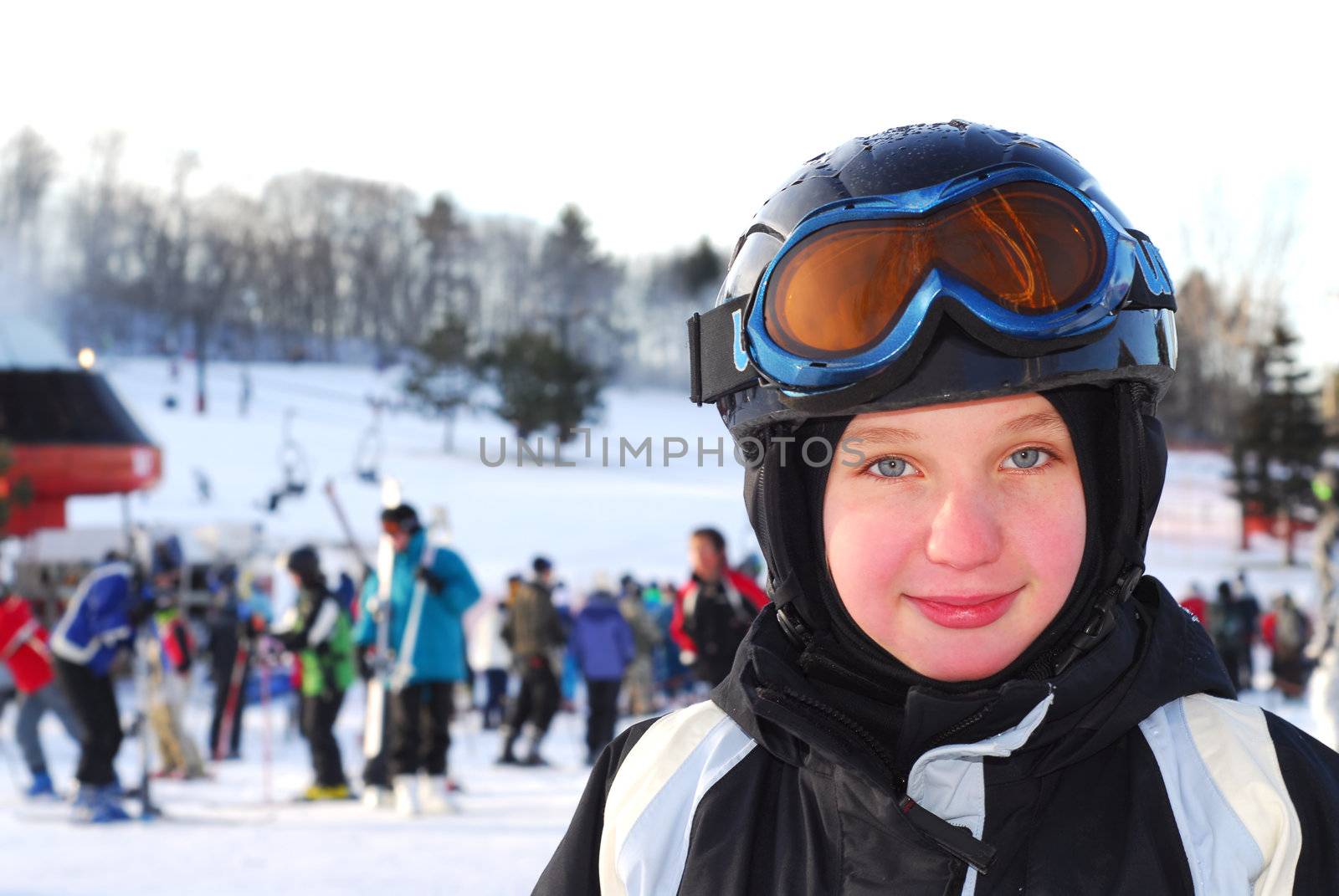 Portrait of a happy girl on downhill ski resort