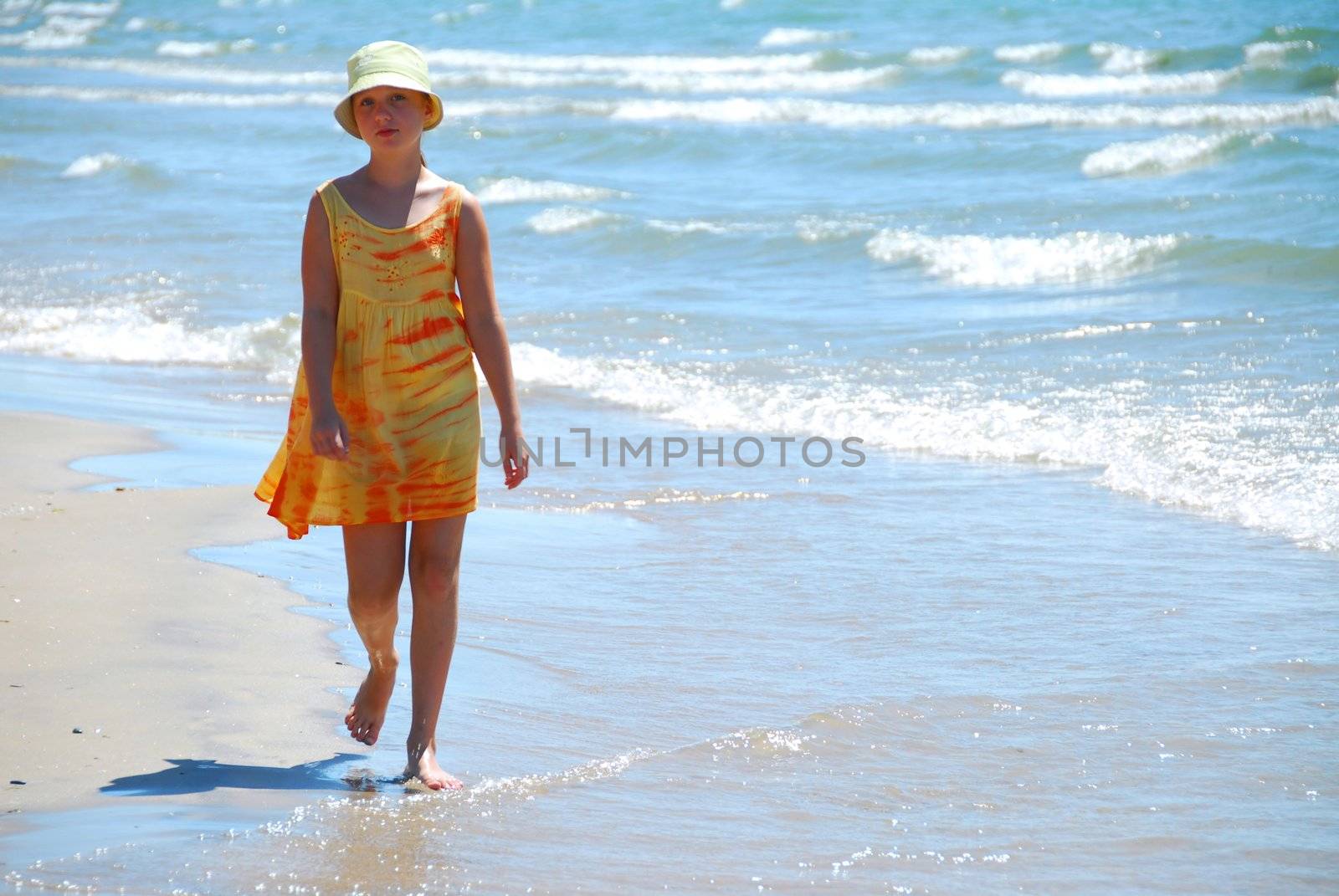 Young girl walking on a beach