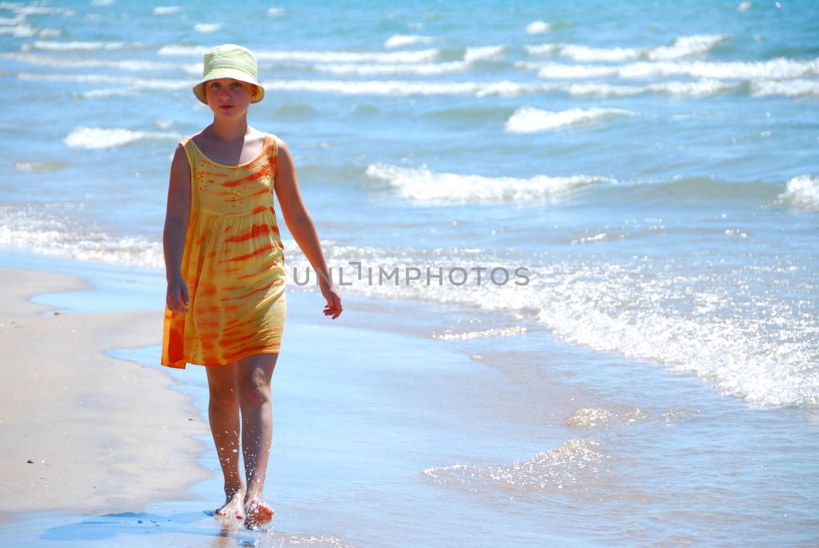 Young girl walking on a beach