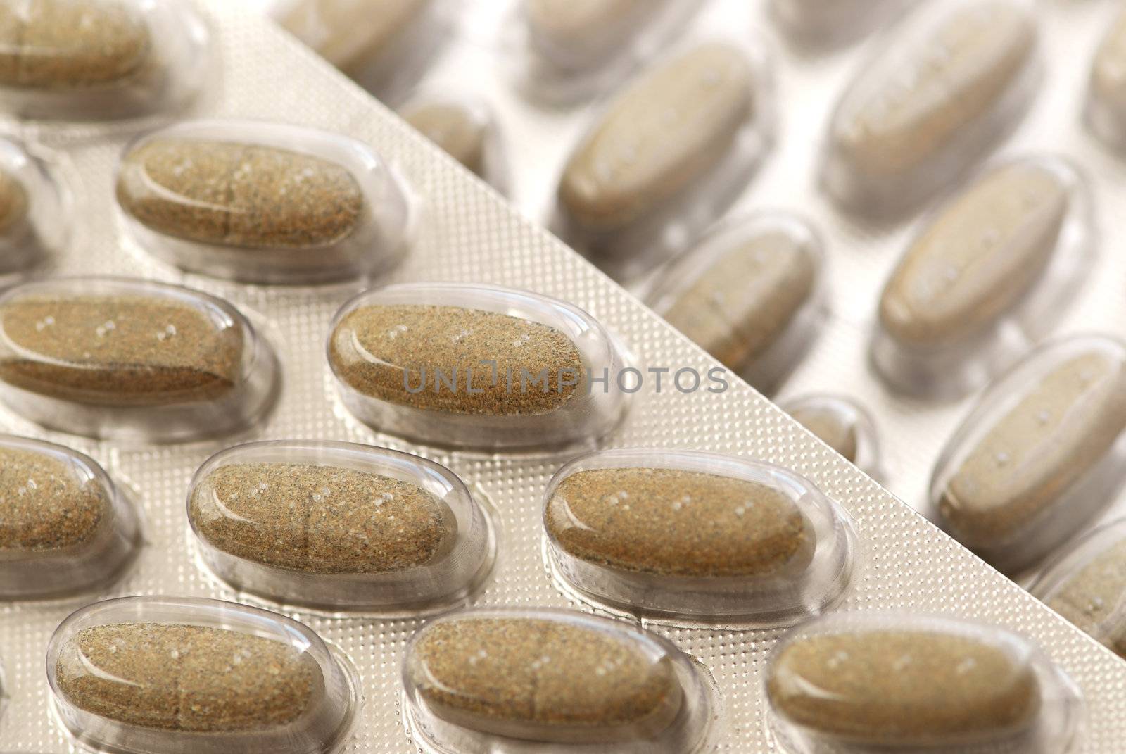 Background of herbal supplement pills close up