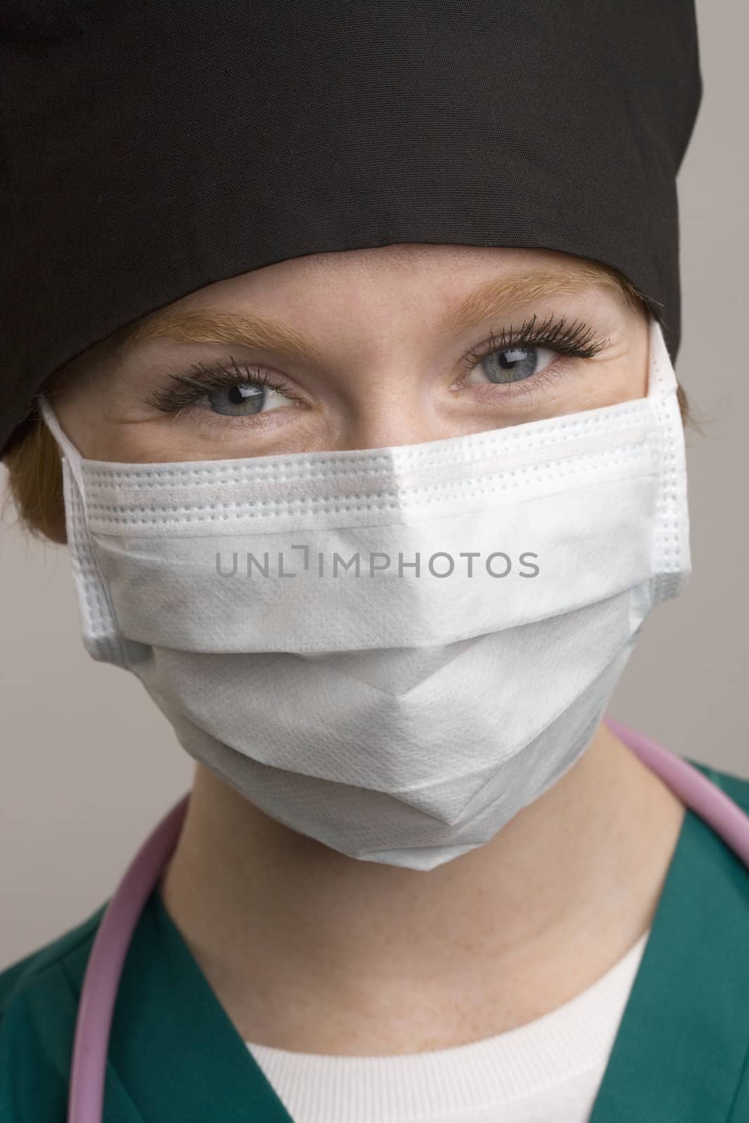 Close up of smiling female medical staff wearing surgical mask