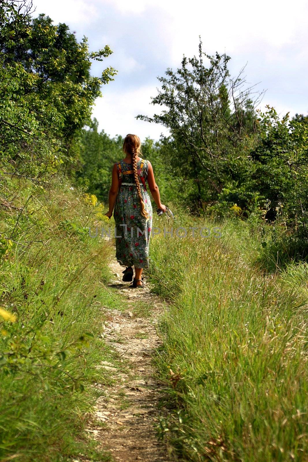 The young woman goes on wood road