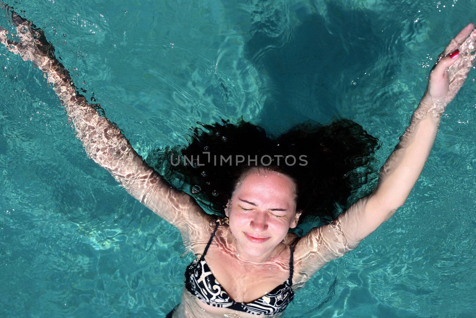 Beautiful woman enjoying summer in the pool