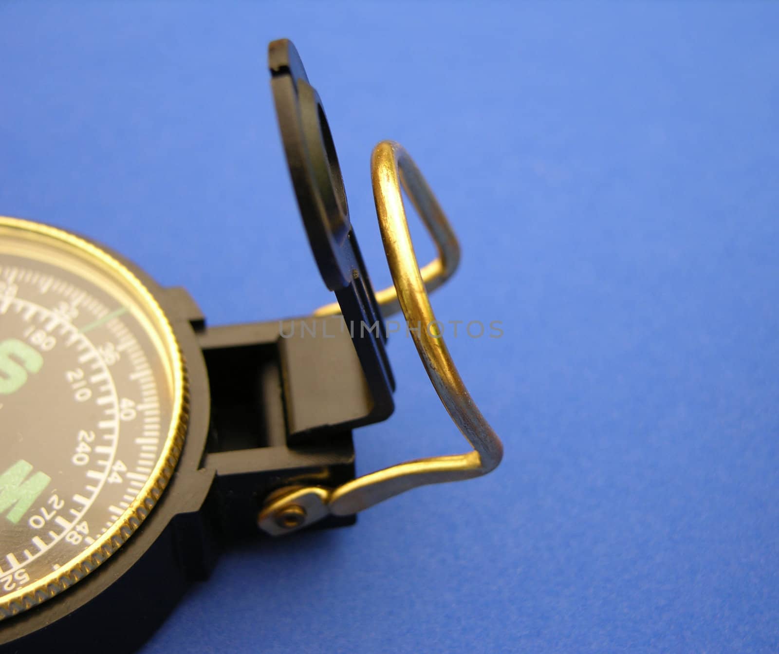           Closeup view of a compass on a blue background