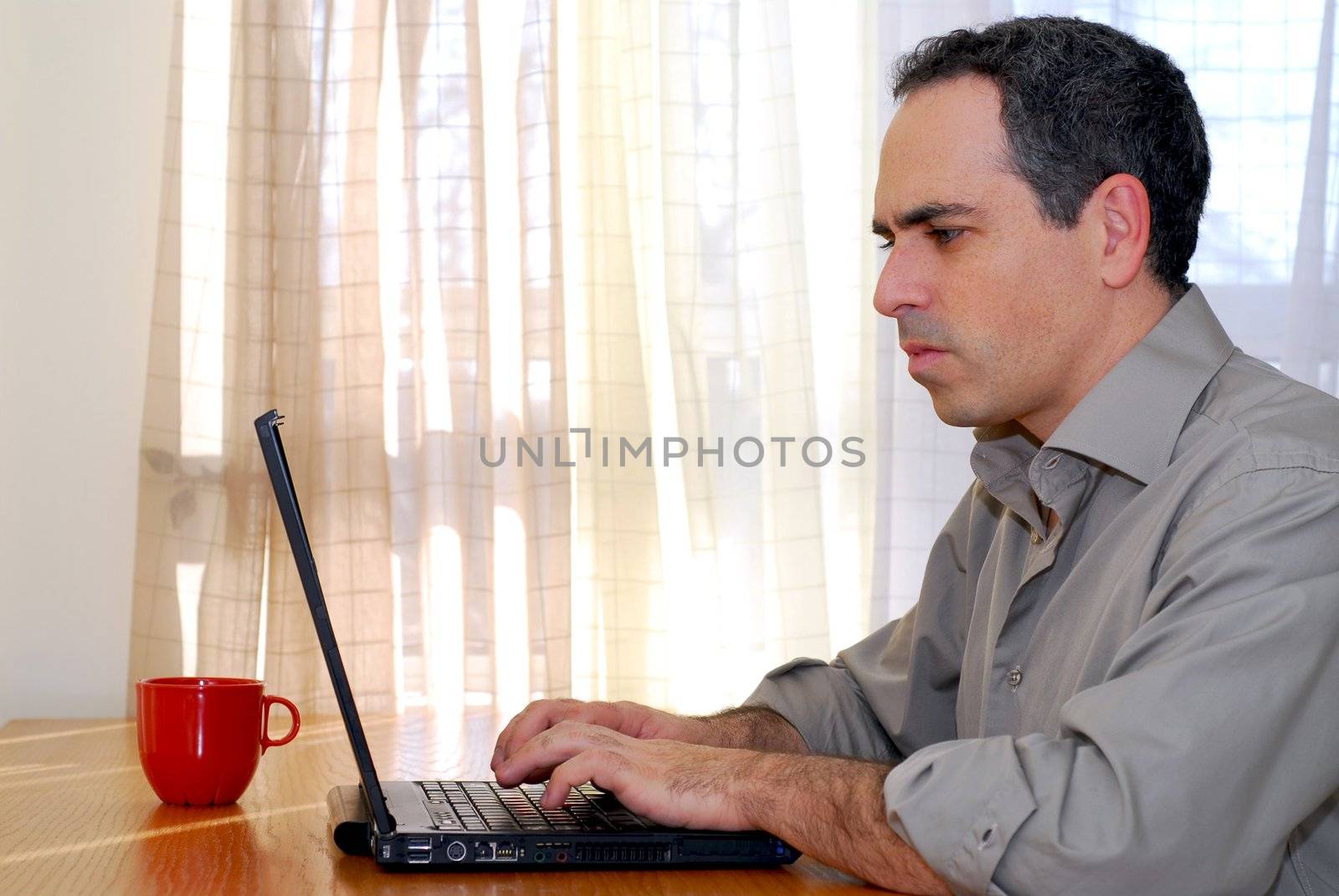 Man sitting at a desk and working on his computer