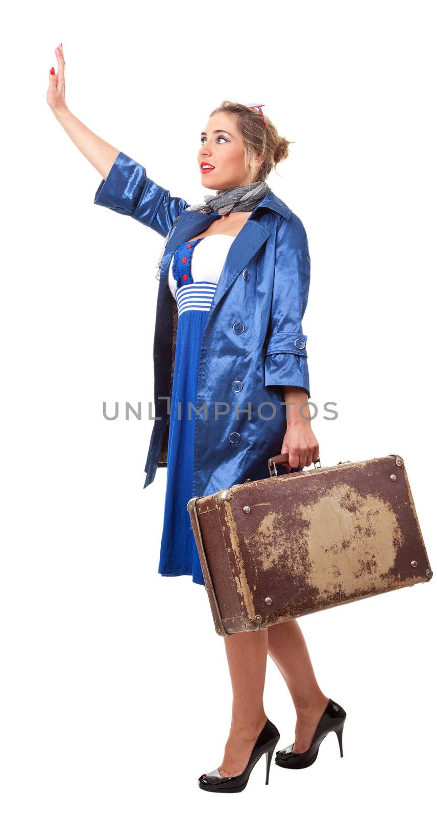 young woman dressed in retro style with an old suitcase