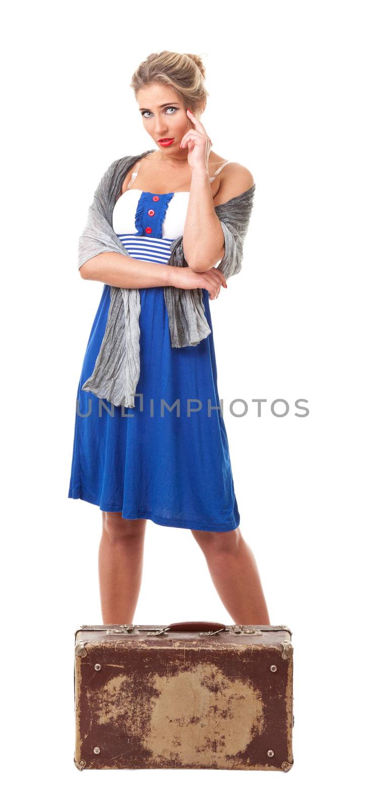 young woman dressed in retro style with an old suitcase