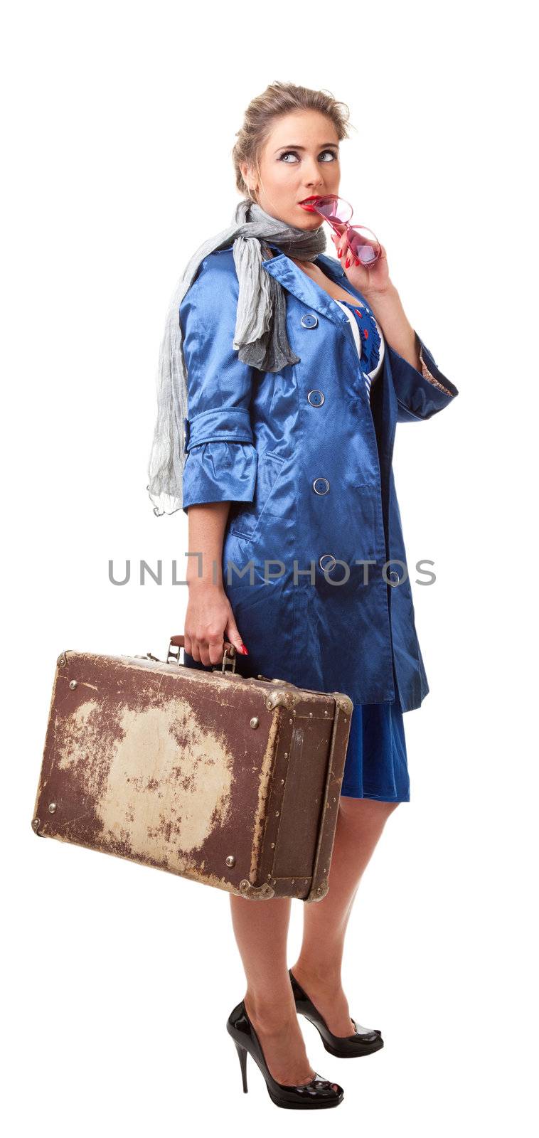 young woman dressed in retro style with an old suitcase
