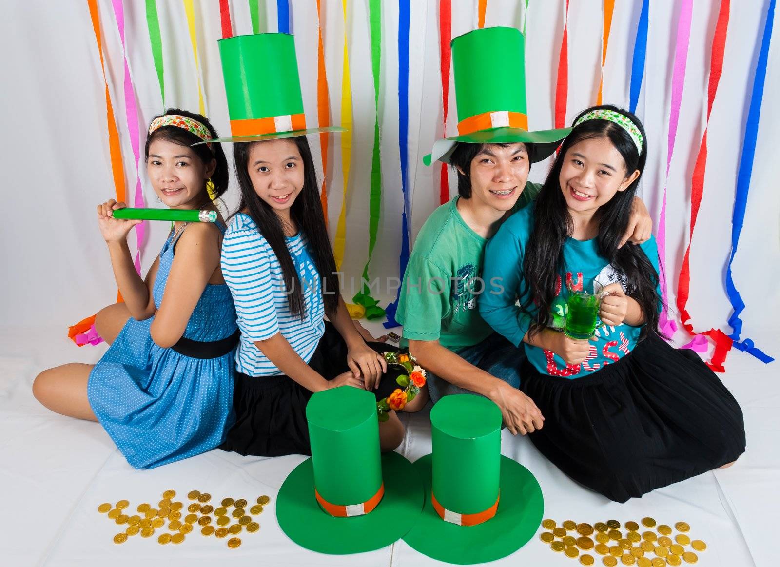Asian Thai girls hold big green hat on St.Patrick's Day, we act in   happiness and celebating feeling