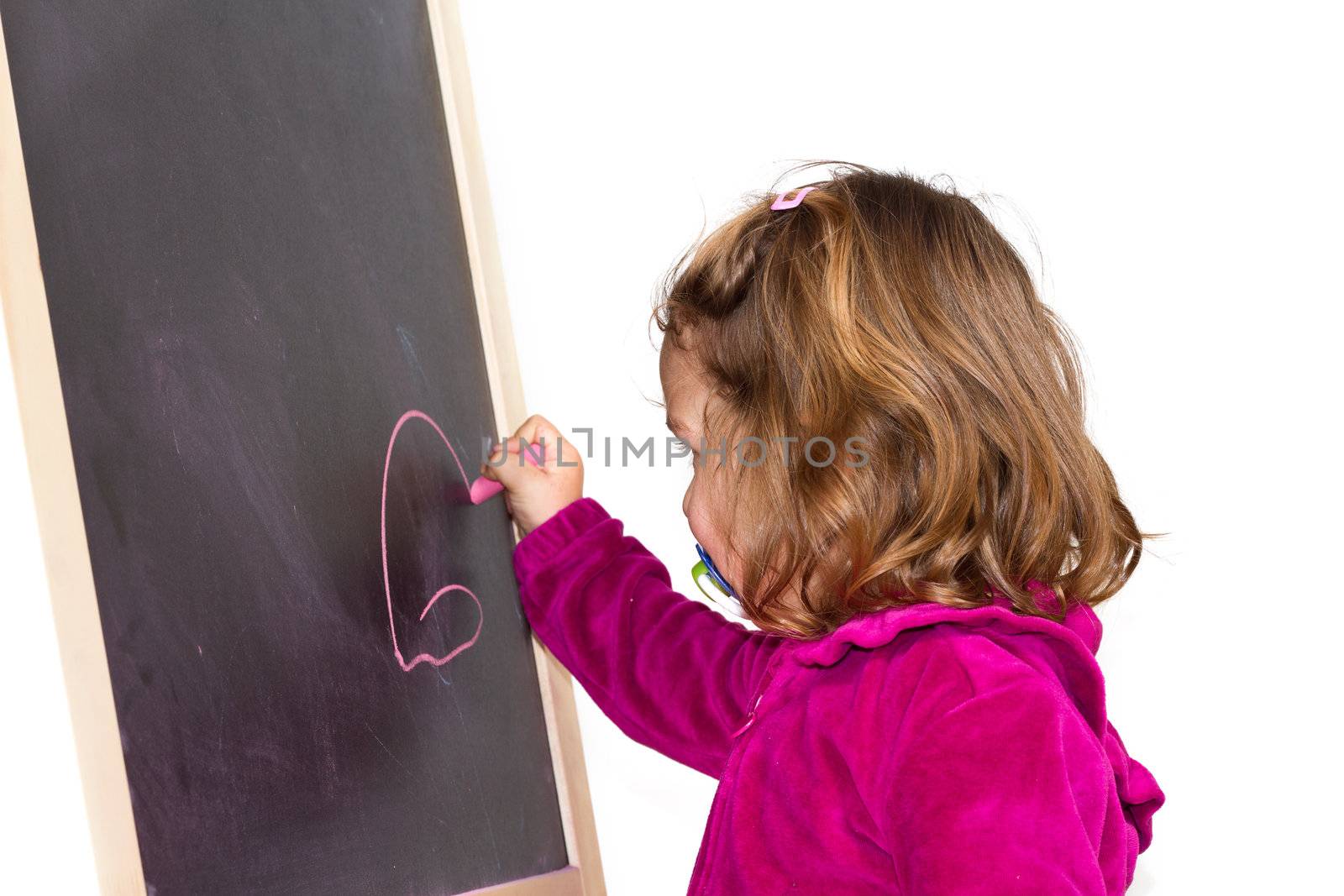 Little girl writing on a blackboard by lsantilli