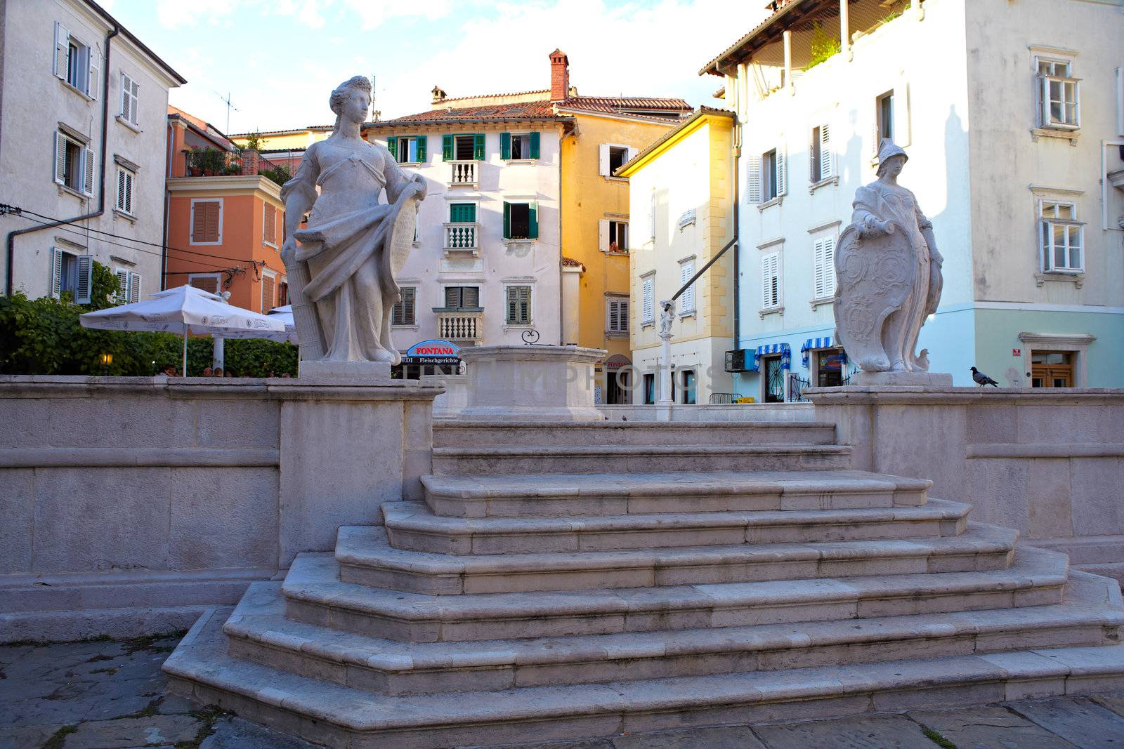 Statues next to the staircase in Piran