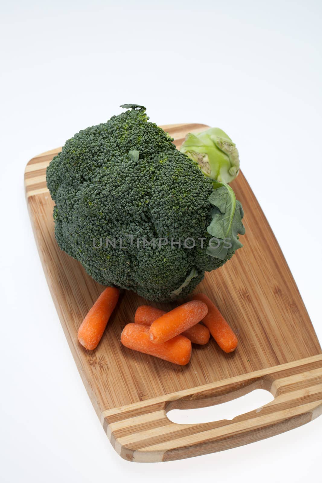 brocolli and carrots on the cutting board on the white background 