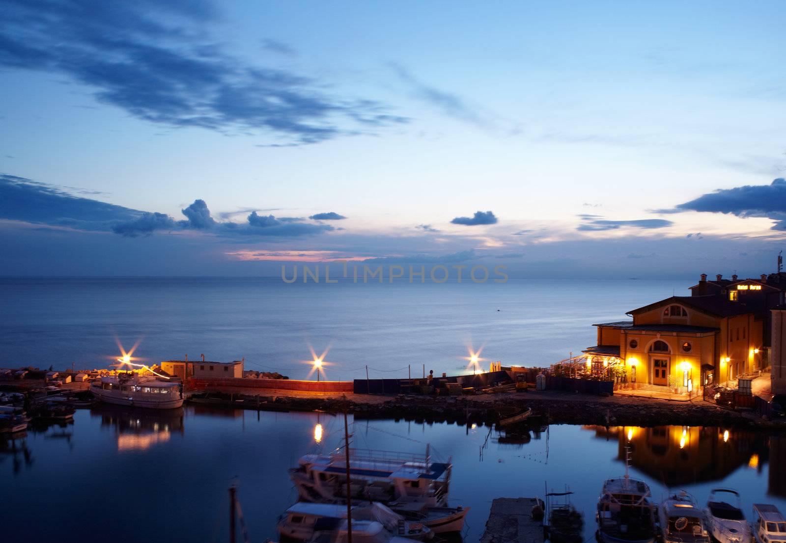 View of boats at sunset in the Piran harbor, Slovenia