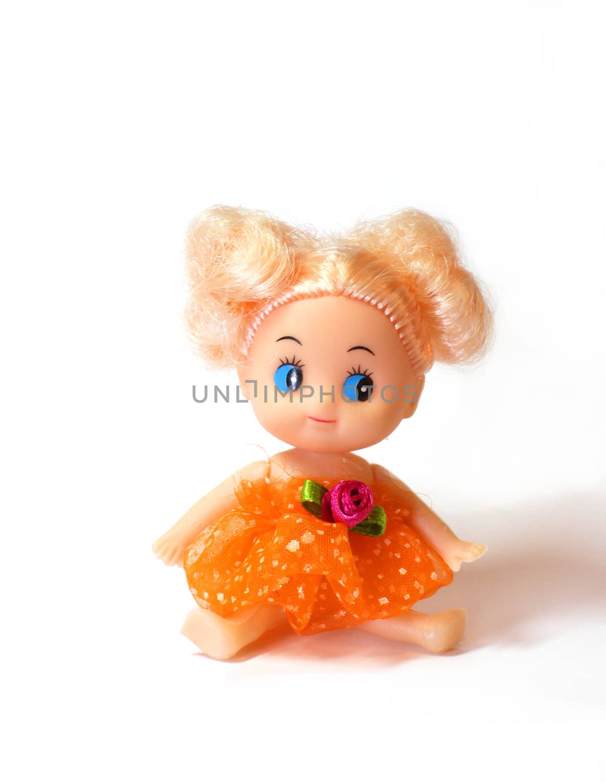 blonde girl baby doll with blue eyes wearing orange dress seated on white background