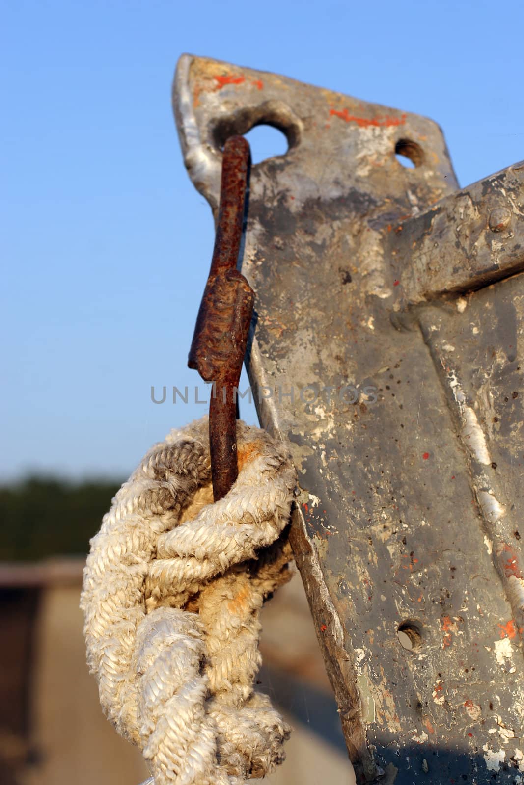 bend of old rope of the bow of the old rusty boat (marine knot). Close up