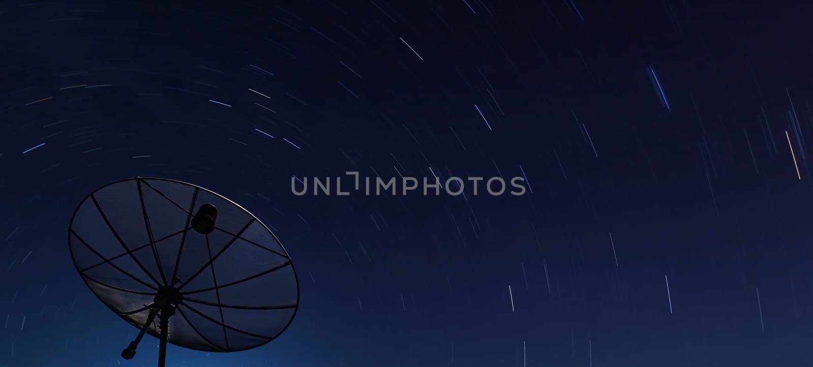 Conceptual of Big Black satellite over spiral star at night