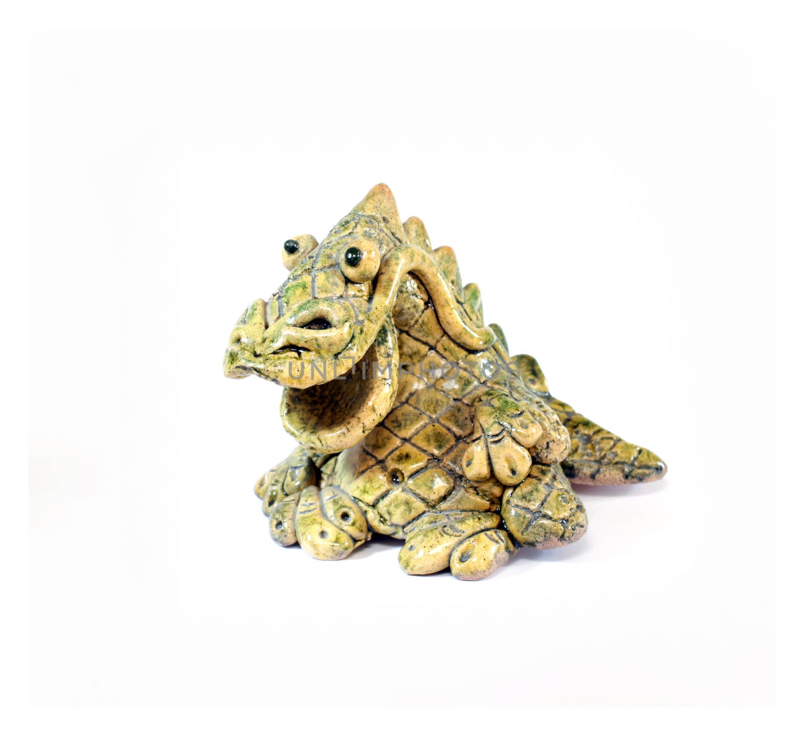 ceramic figurine of smiling yellow and green dragon - the symbol of 2012 year