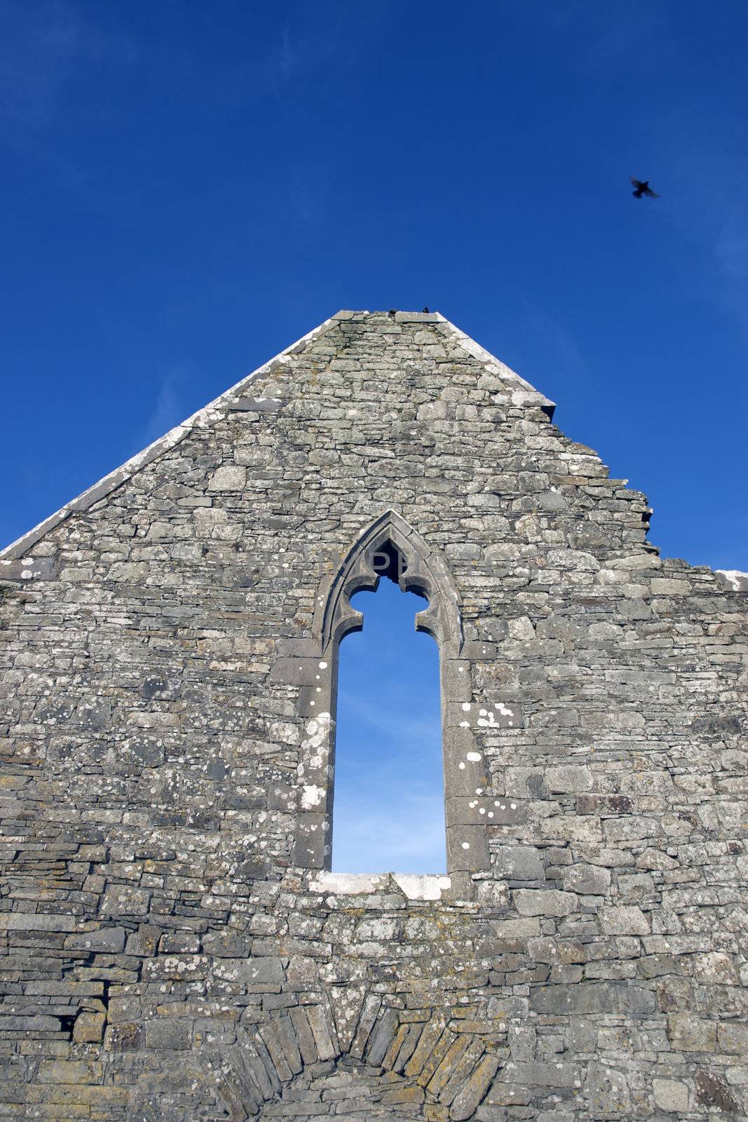 ancient old arched window in ruin walls of historic building in Ireland