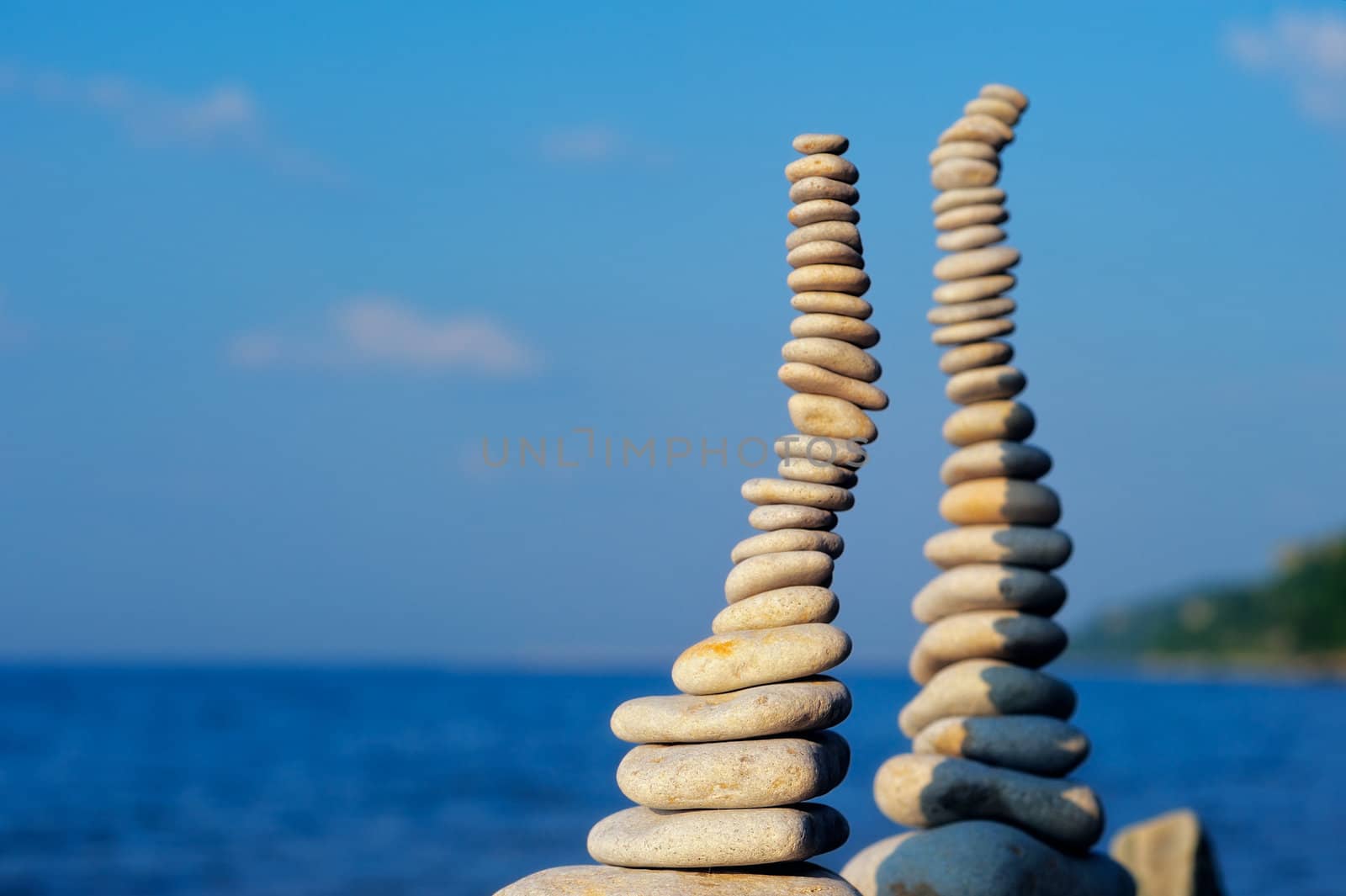 Two pile of pebbles in the balance on the seacoast