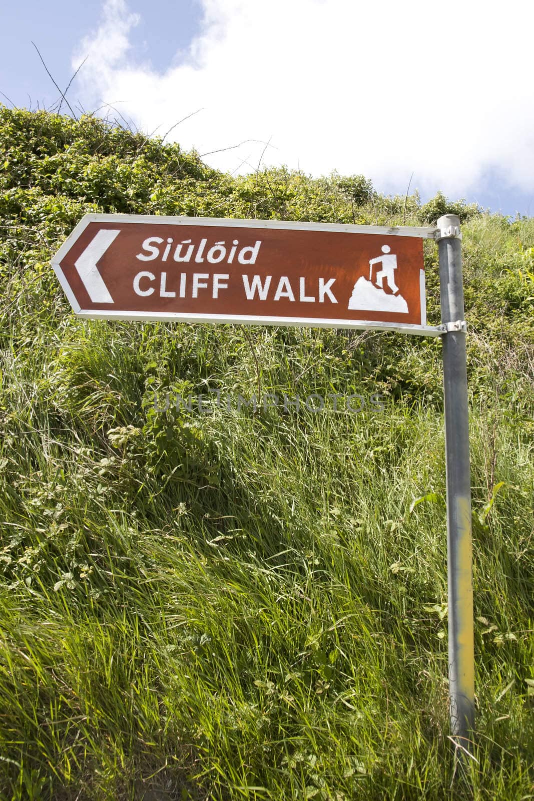 brown metal direction sign for a cliff walk by morrbyte