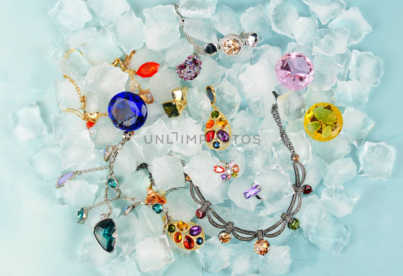 Jewels at blue cube of ice background