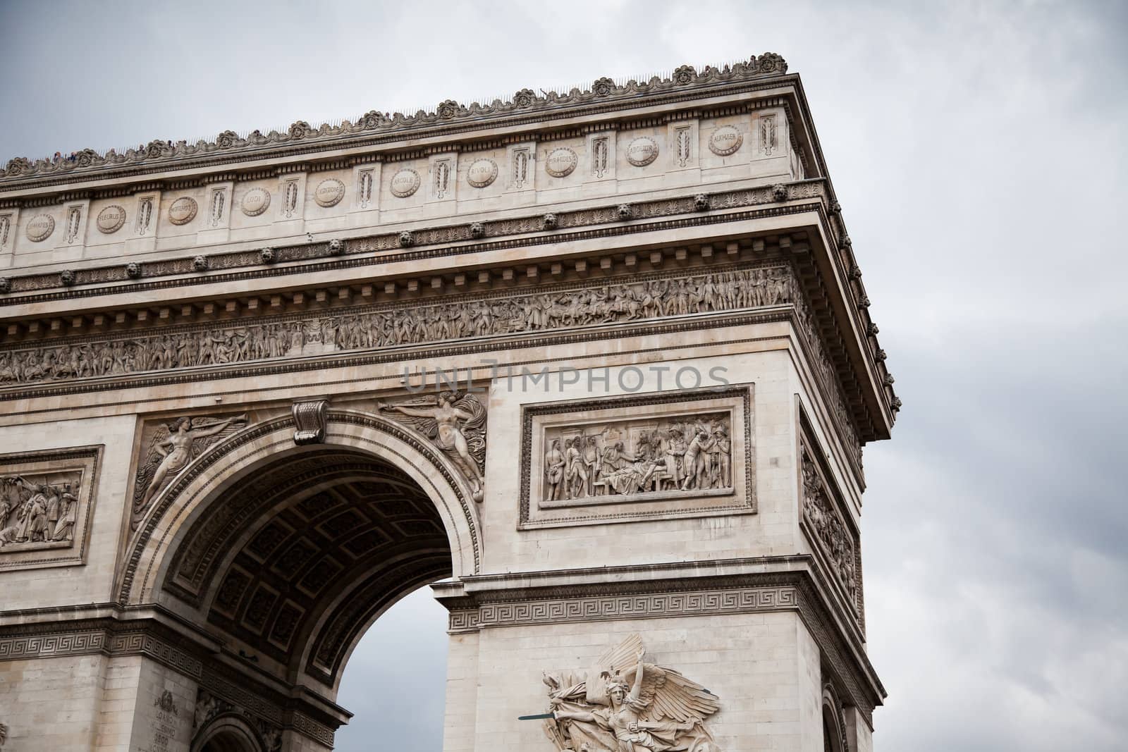 Arc de Triomphe (Arch of Triumph) on gloomy sky background