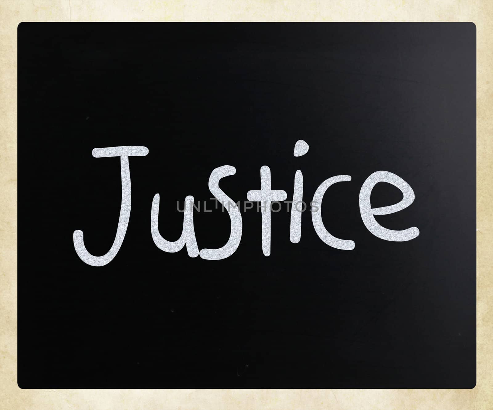 "Justice" handwritten with white chalk on a blackboard