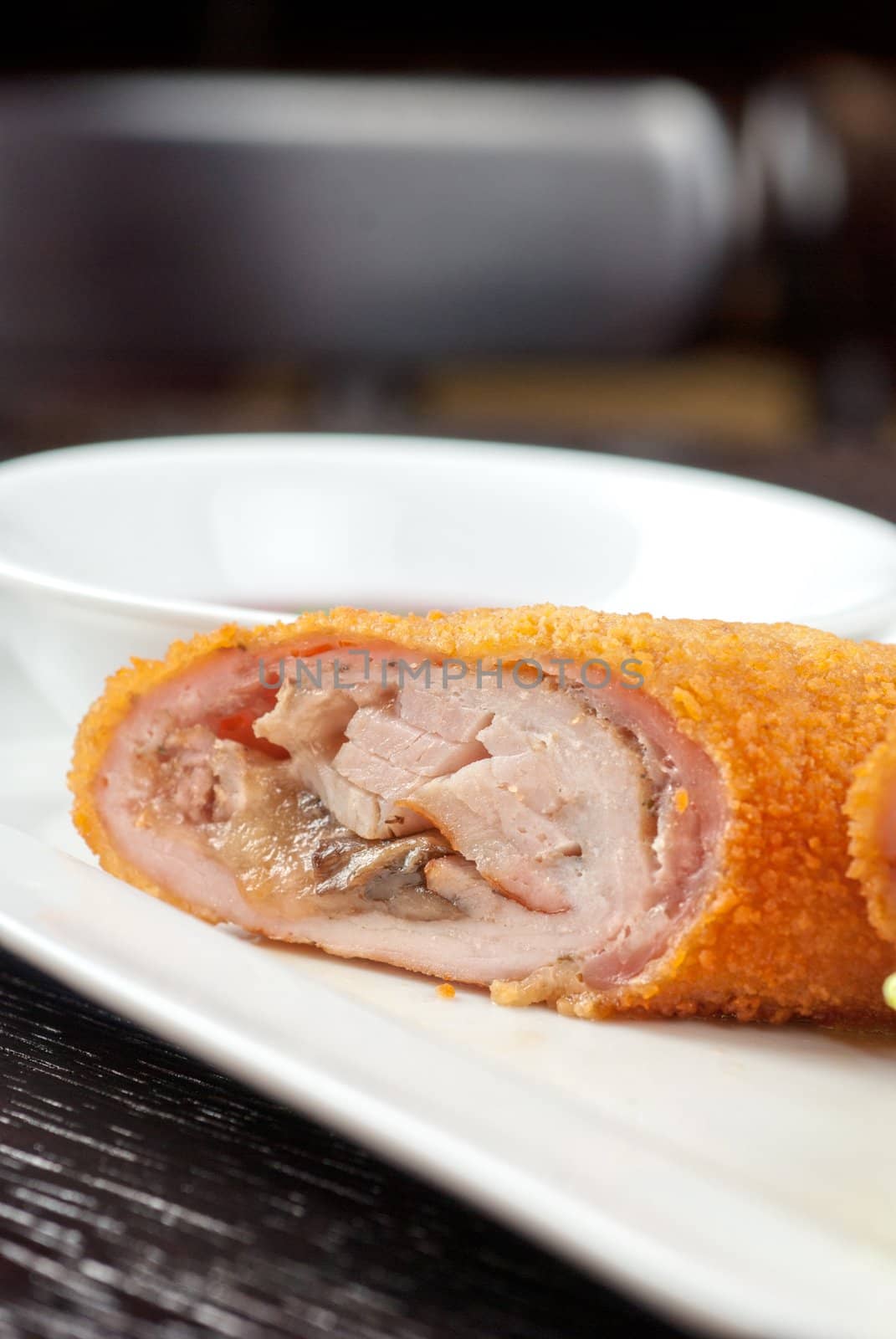 Closeup of rolls from pork meat, champignon mushroom, cheese and sauce