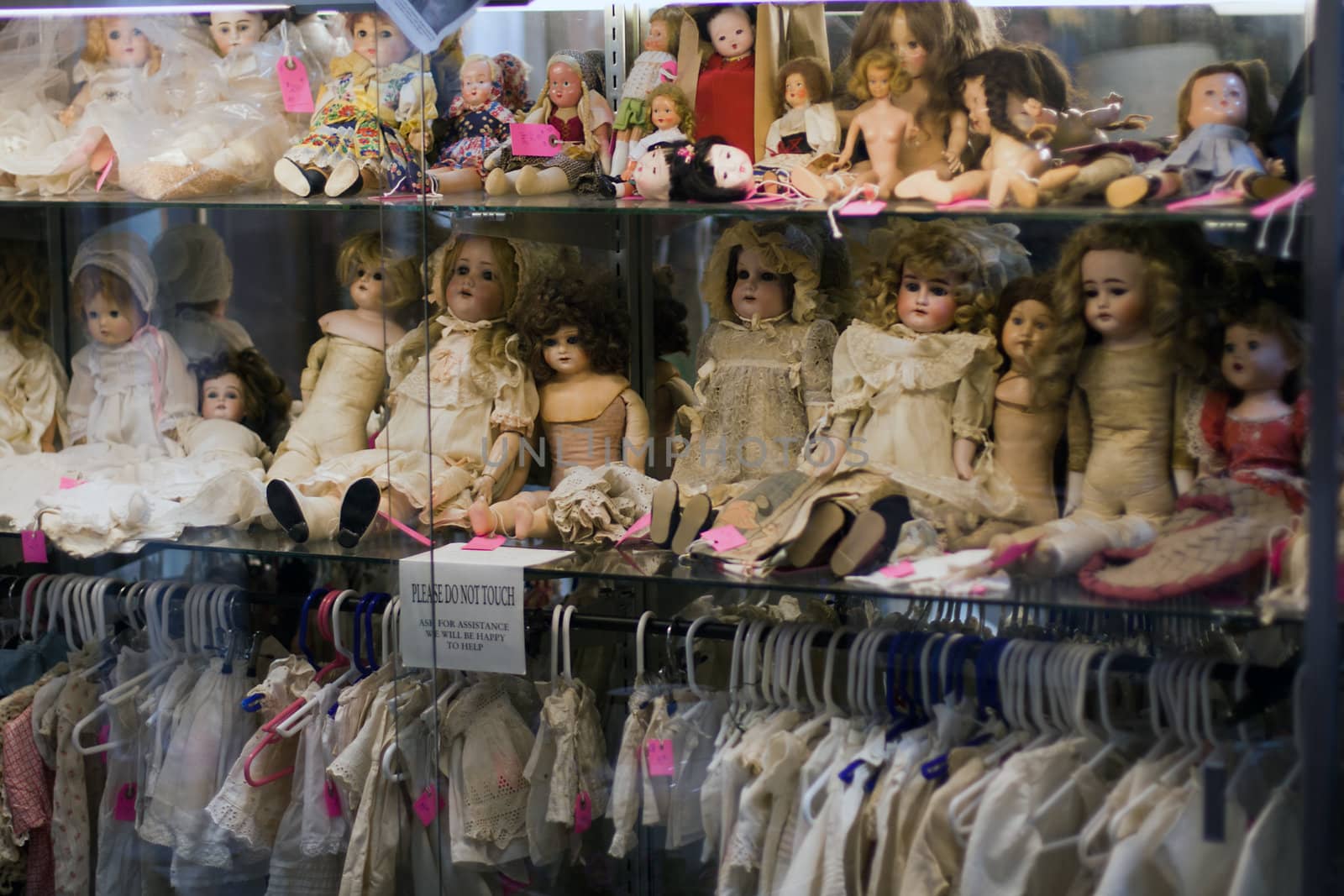 Showcase full with antique dolls and clothes