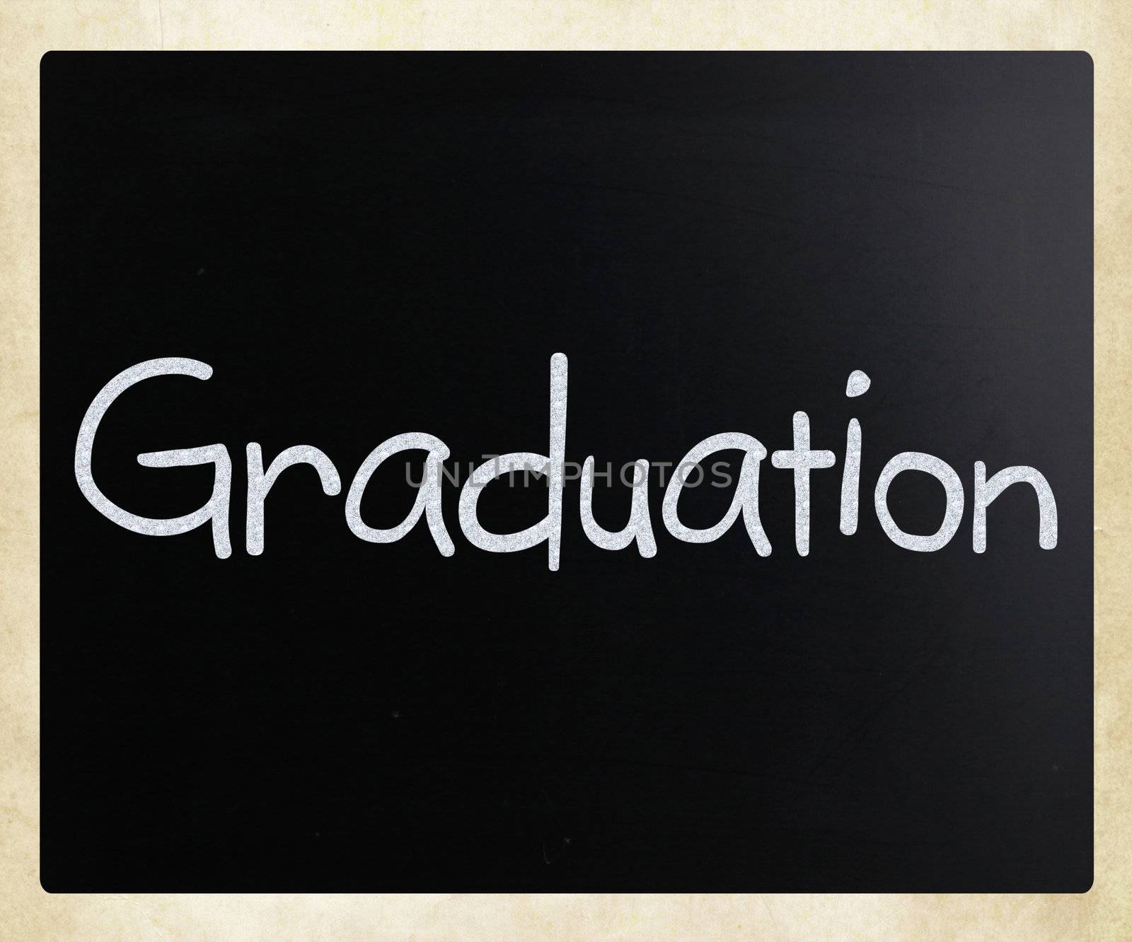The word "Graduation" handwritten with white chalk on a blackboard