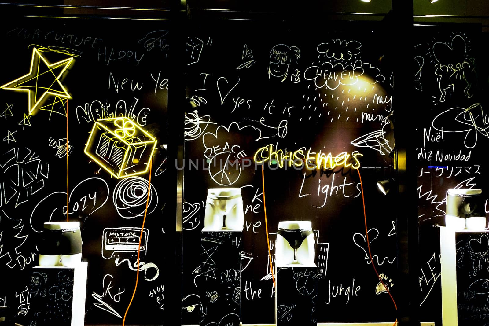 Modern underwear store display with writings on the wall and manikins wearing underwear