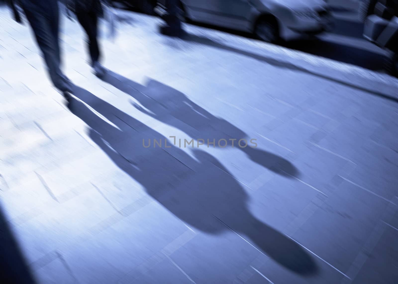 Conceptual image of a backlit couple on the move in the public room. Use your fantasi - make your story. Intentional motion blur.