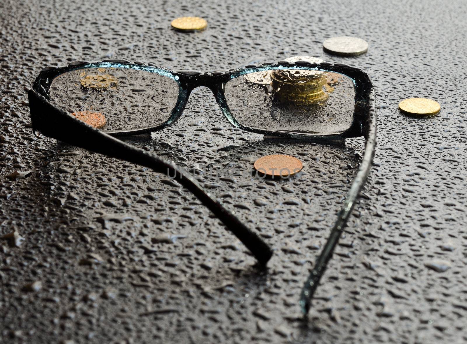 Money seen through the lens of a pair of glasses