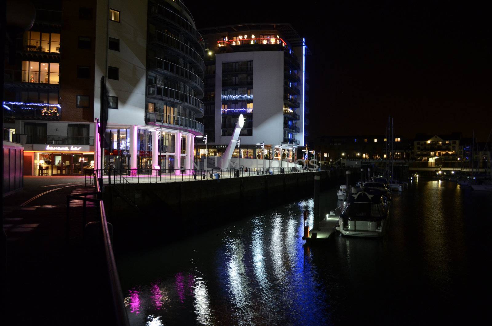 Illuminated evening Marina view with leisure boats and restaurants