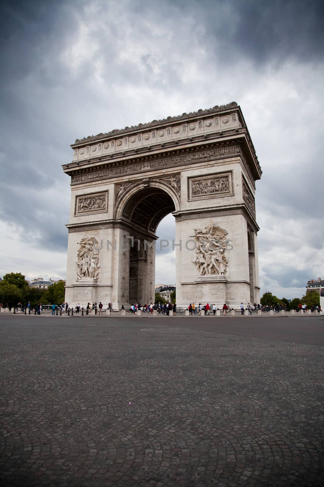 Arc de Triomphe (Arch of Triumph) on gloomy sky background