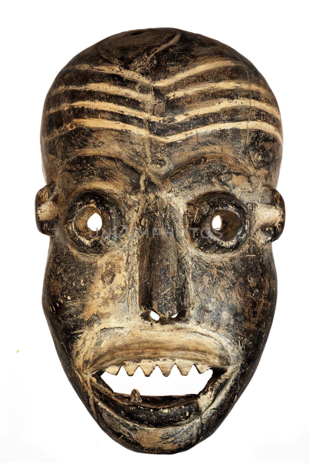 Wooden carved African tribal mask, dark wood with painted face. Isolated on white background. Congo, Africa