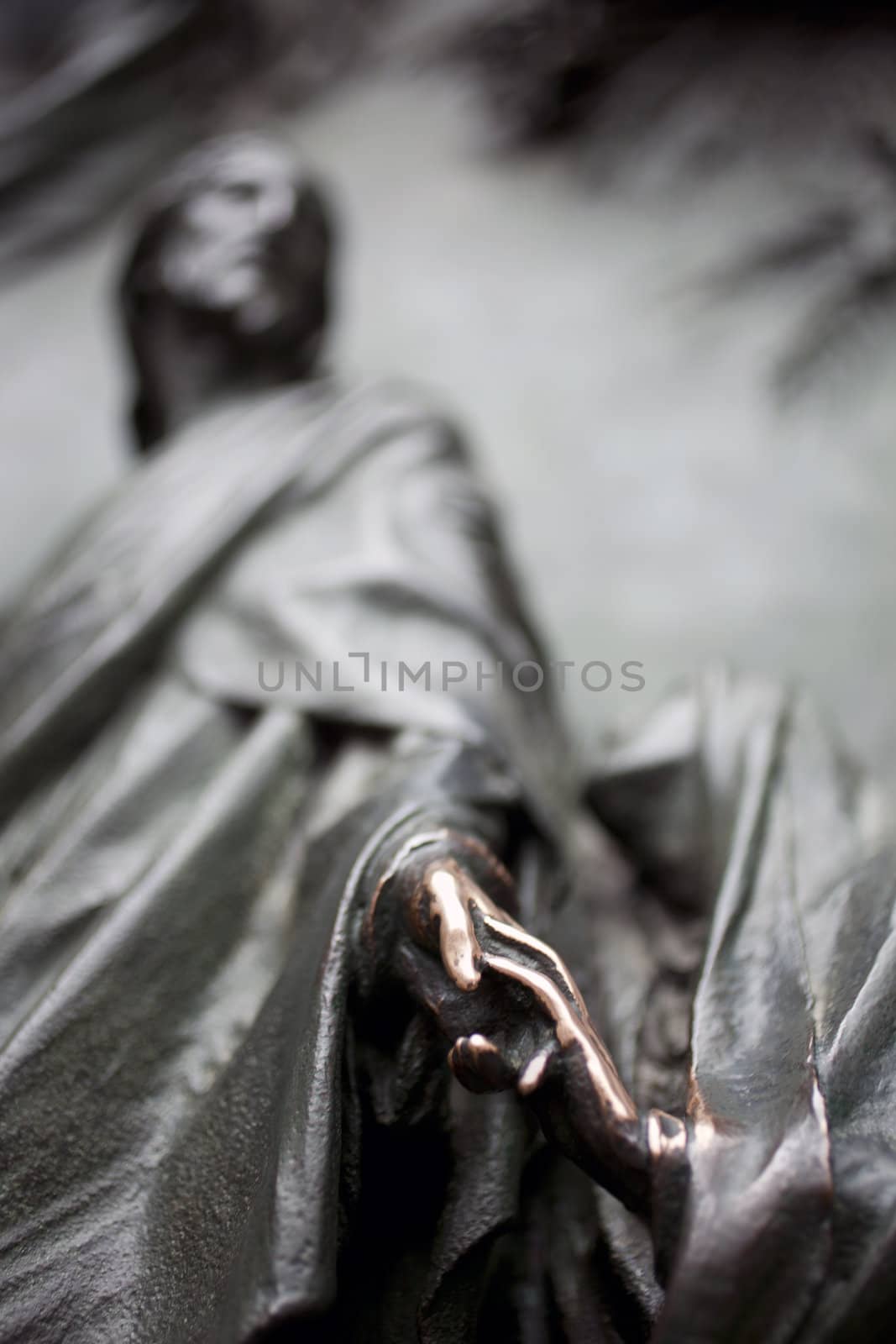 Virgin Mary touching hand of Jesus - Sculpture on the bronze portal