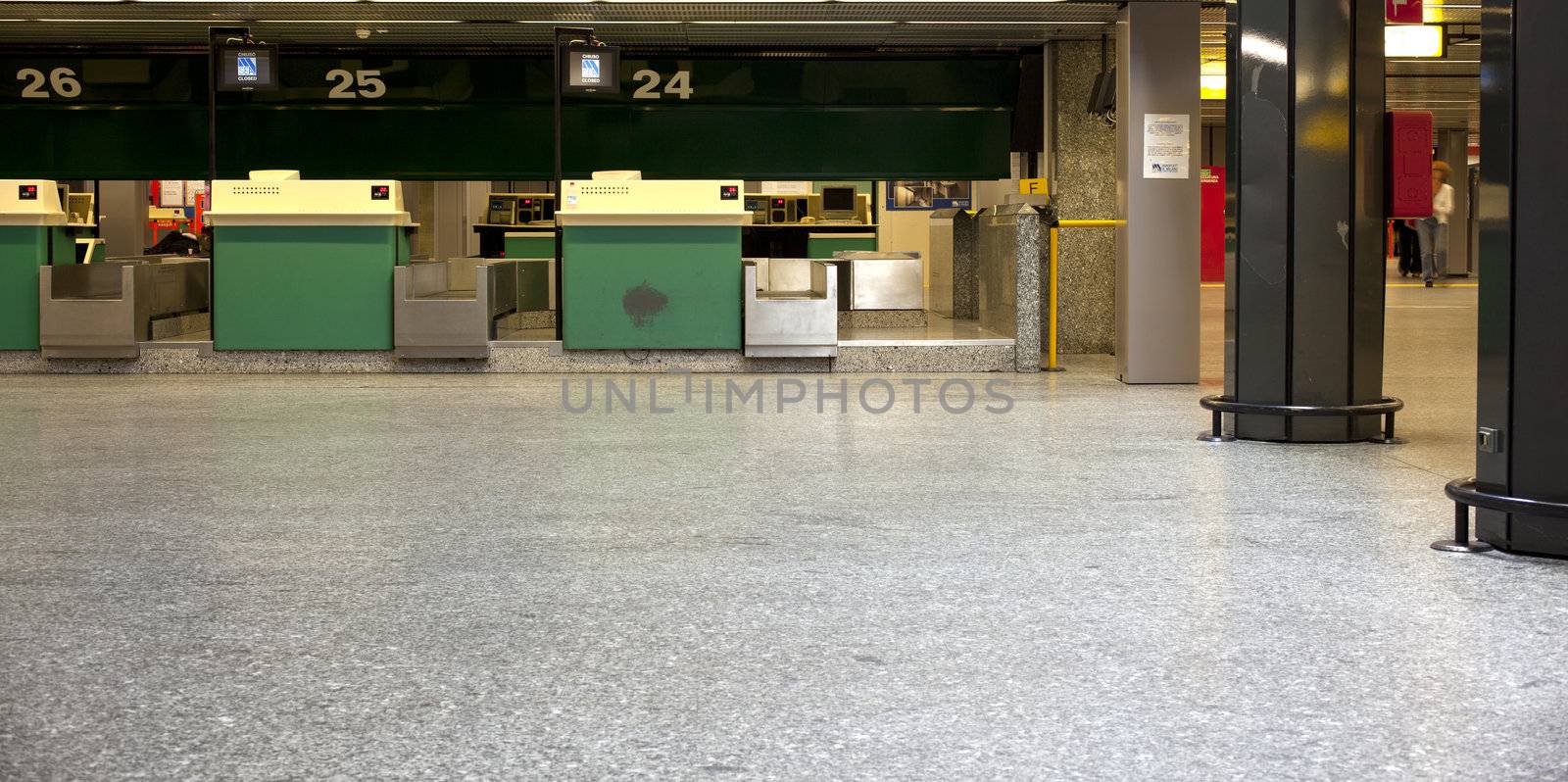 Green desks in airport hall