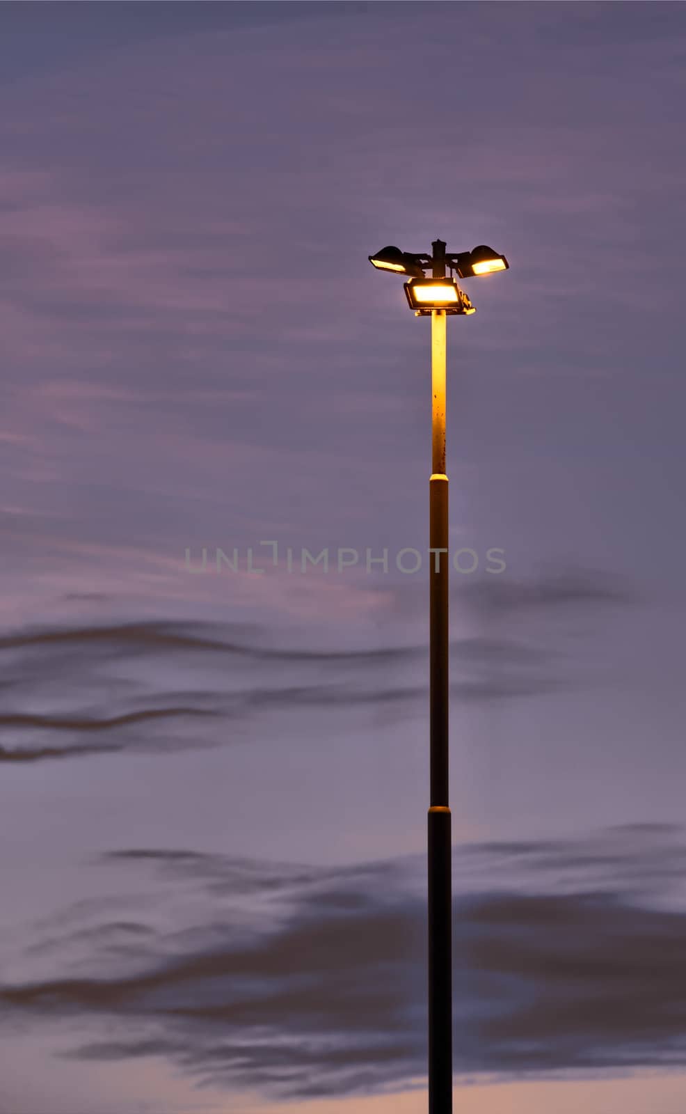 Lighting pole at night in an industrial area.