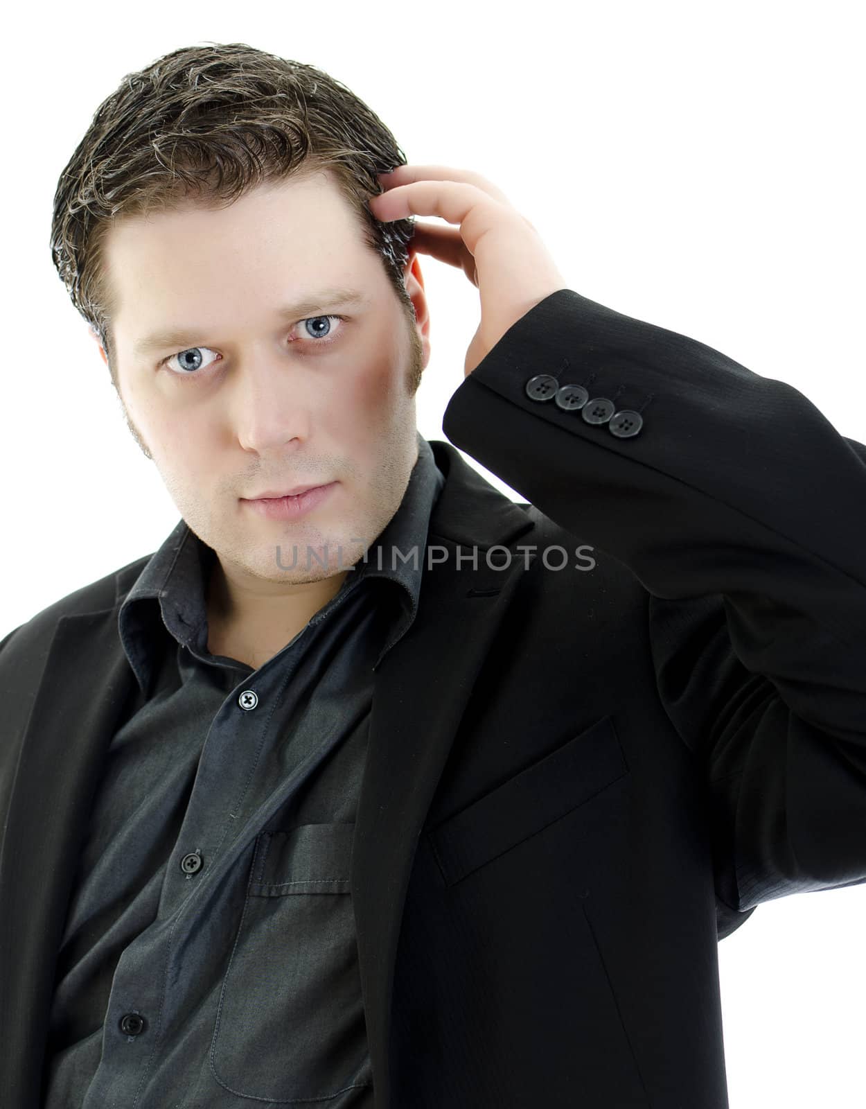 Portrait of a handsome young business man straightening his hair. Isolated on white background with copy space.