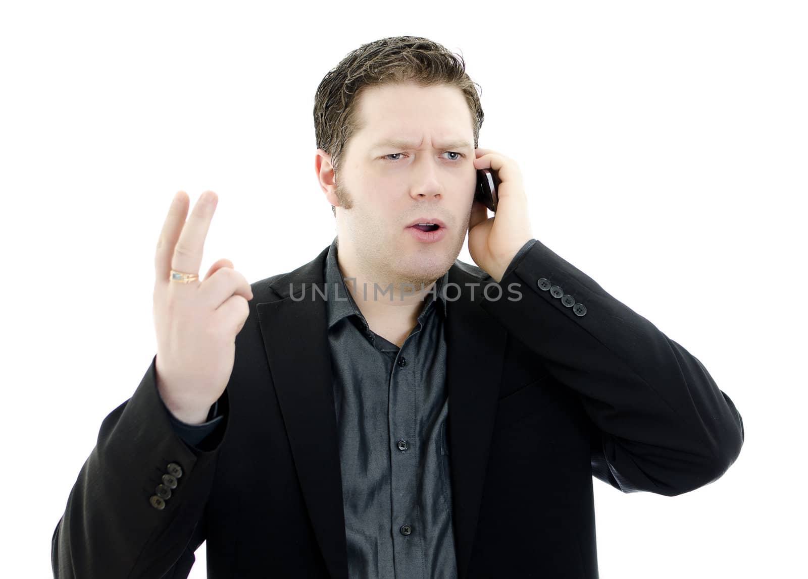 Portrait of a handsome young business man talking on mobile phone. Isolated on white background with copy space.